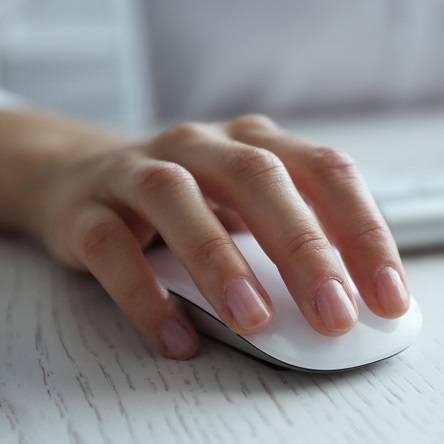 Female,Hand,With,Computer,Mouse,On,Table,,Closeup